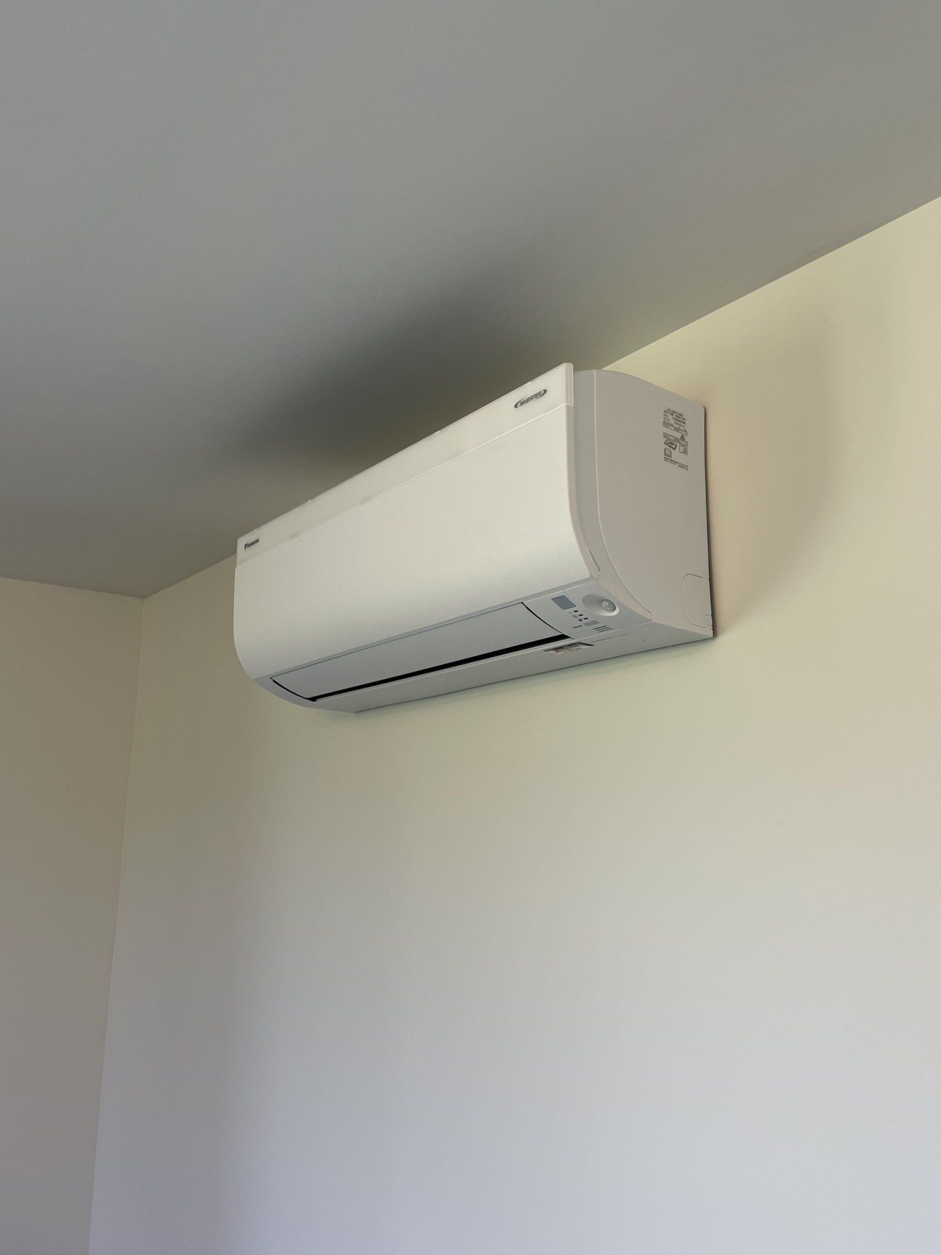 Hi-wall heat pump installed on wall
