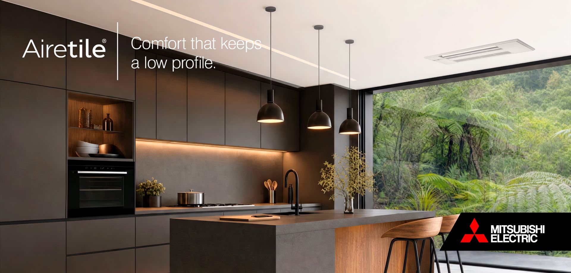 Mitsubishi Electric Airetile in ceiling of modern New Zealand kitchen with large glass window looking out on lush green ferns.