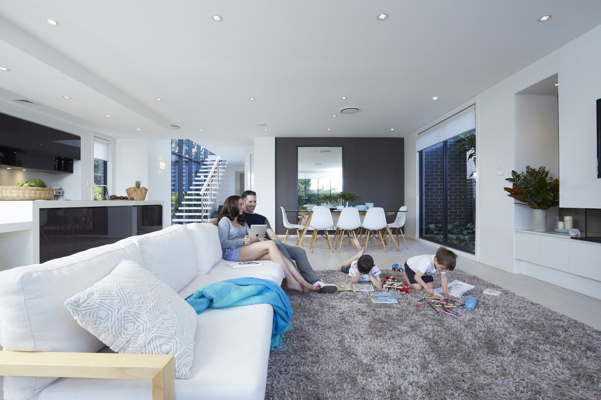 Ducted heat pump in living room with family