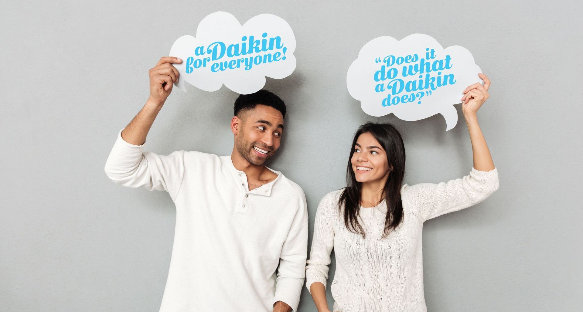 People holding signs Does It Do What A Daikin Does
