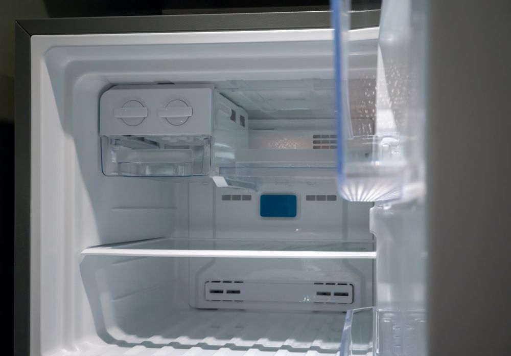 The Inside of an Empty Refrigerator With the Door Open — Bradmark Appliance Service in Garbutt, QLD