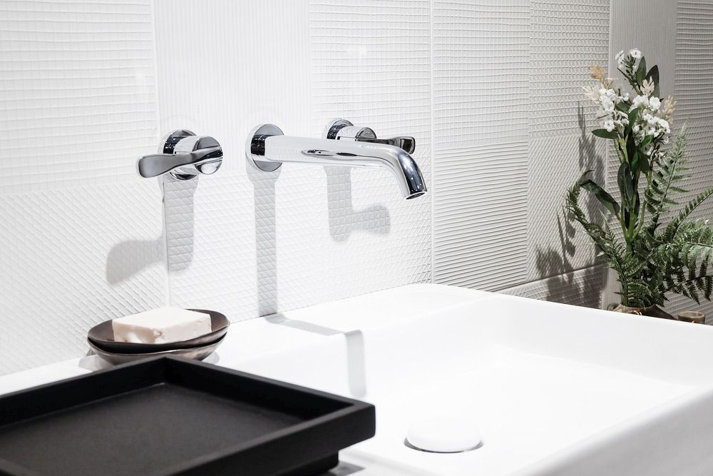 A Bathroom Sink With Three Faucets and a Black Tray — Bradmark Appliance Service in Garbutt, QLD
