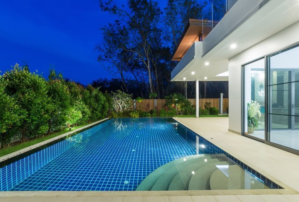 A Large Swimming Pool In The Backyard Of A House — Kingscliff Pool Shop In Kingscliff, NSW