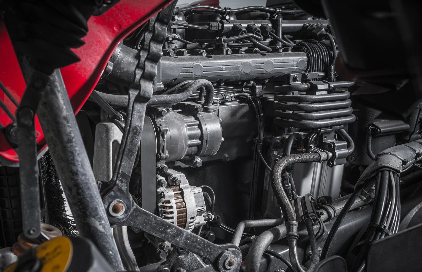 Close-up of a truck engine with various components and black and red details.