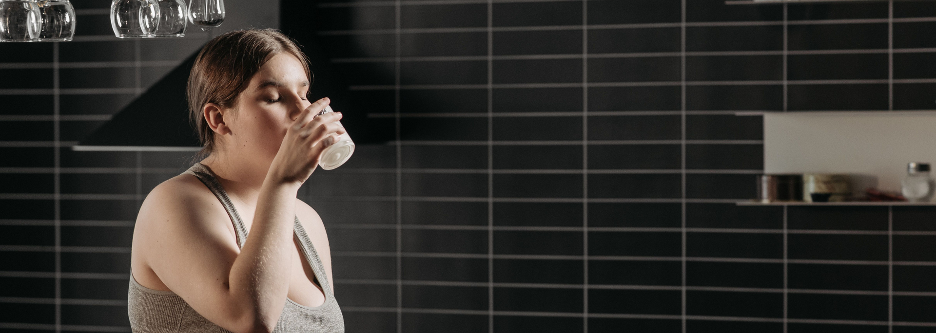 Picture of a woman drinking a protein shake. 