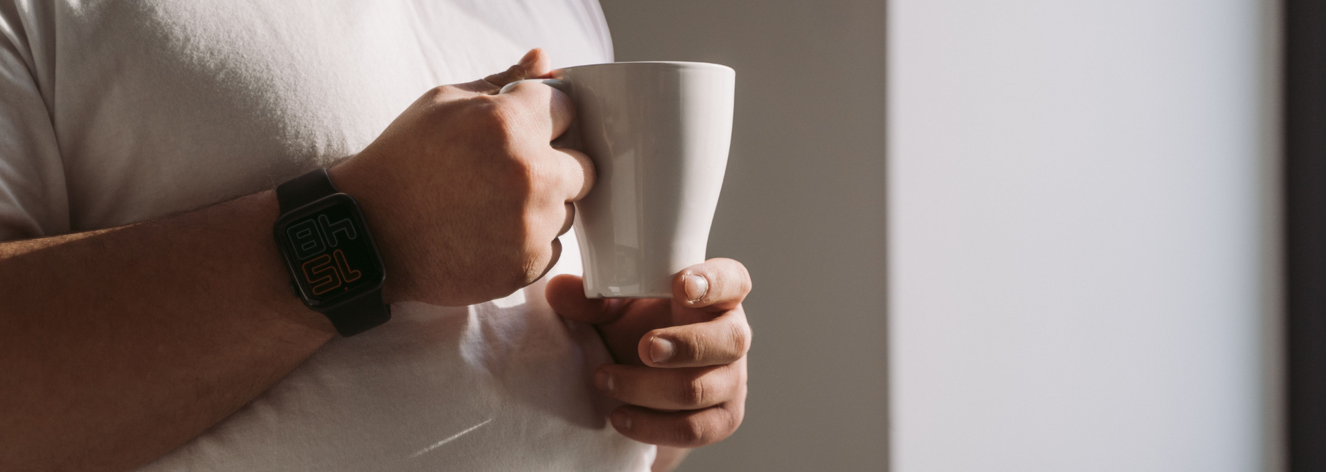Picture of an overweight man holding a drink. 