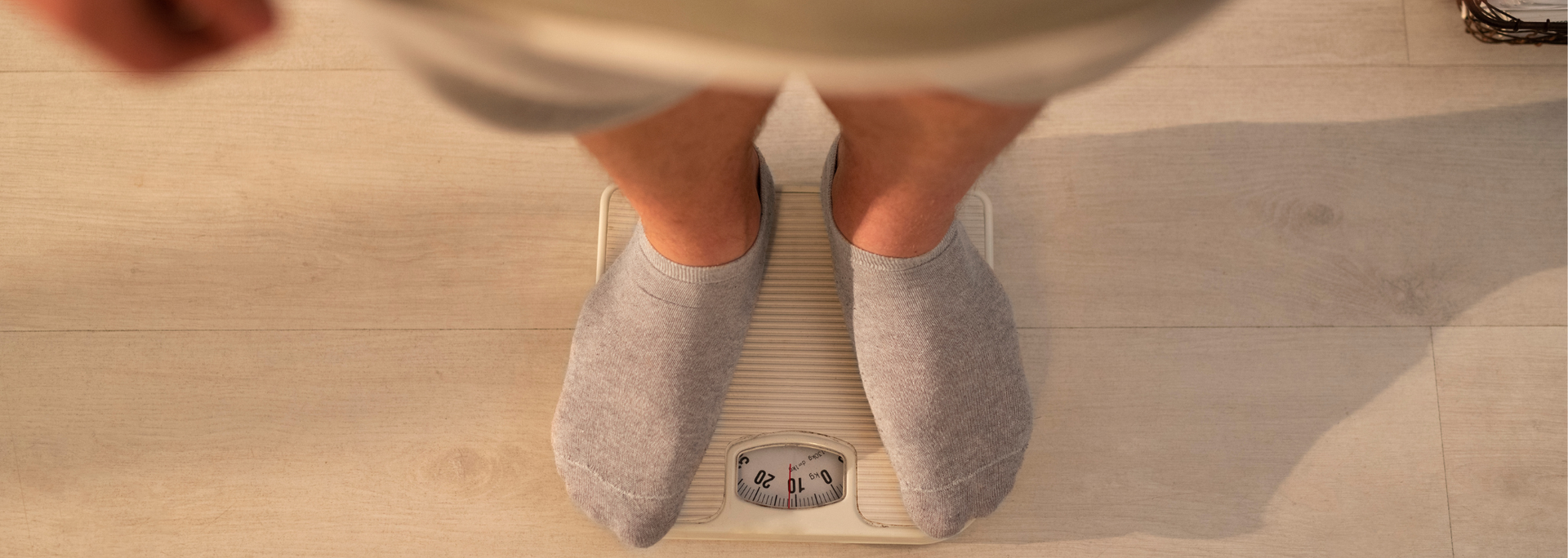 Picture of a man standing on scales. Picture of a man standing on scales.