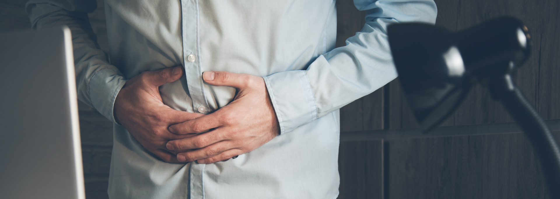 Picture of person holding belly as if experiencing gastrointestinal distress. Picture of person holding belly as if experiencing gastrointestinal distress.