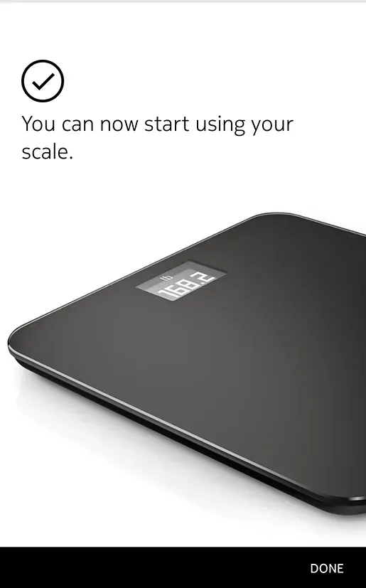 A black scale is sitting on a white surface.