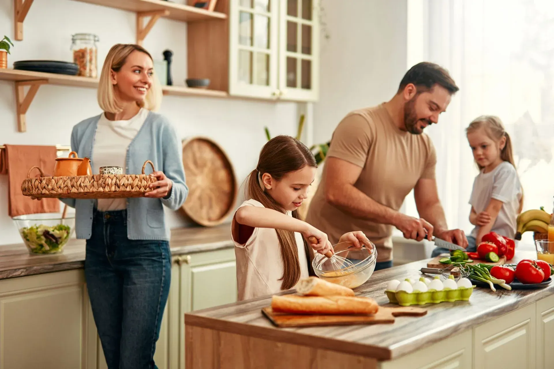 A family is preparing food together in the kitchen.