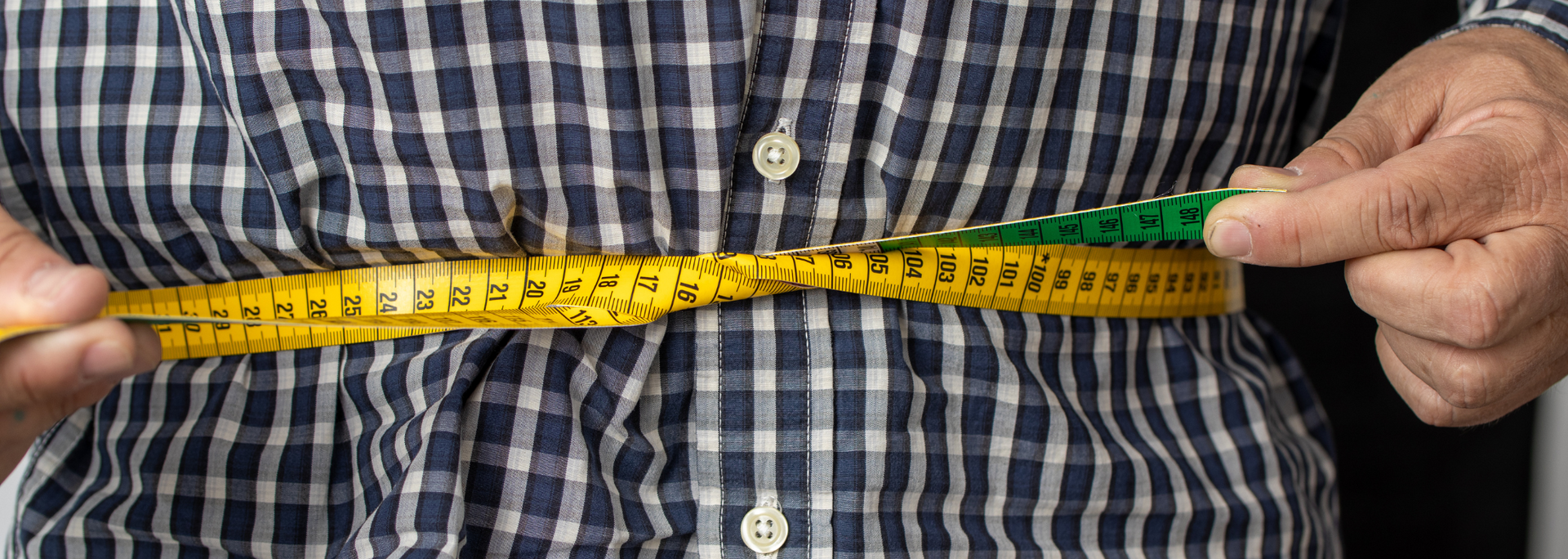 Picture of tape measure around a person's waist. Picture of tape measure around a person's waist.
