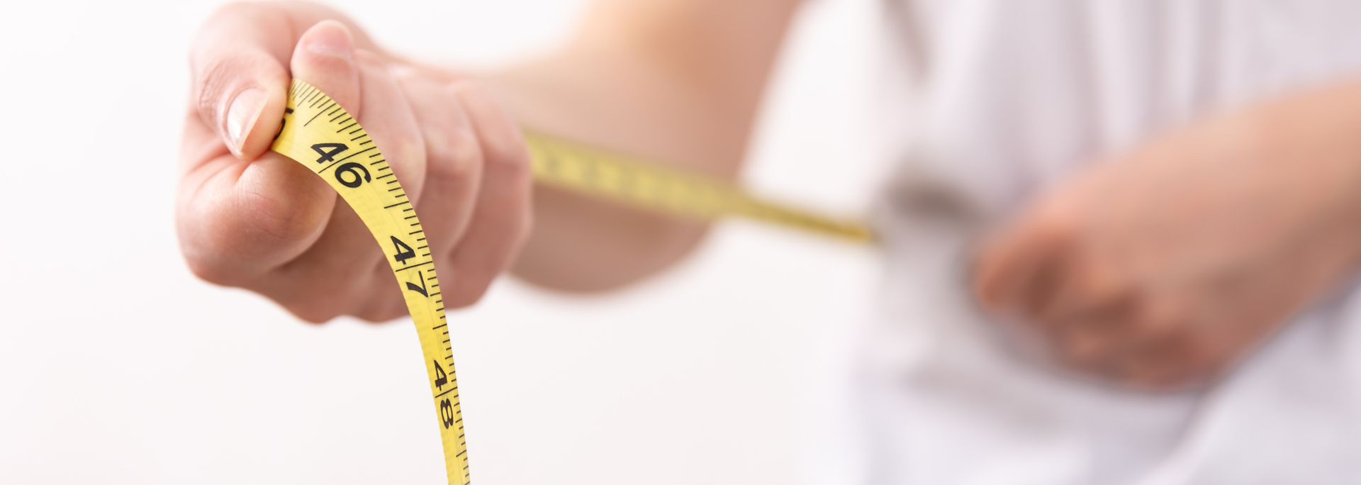 Picture of someone measuring themselves. 