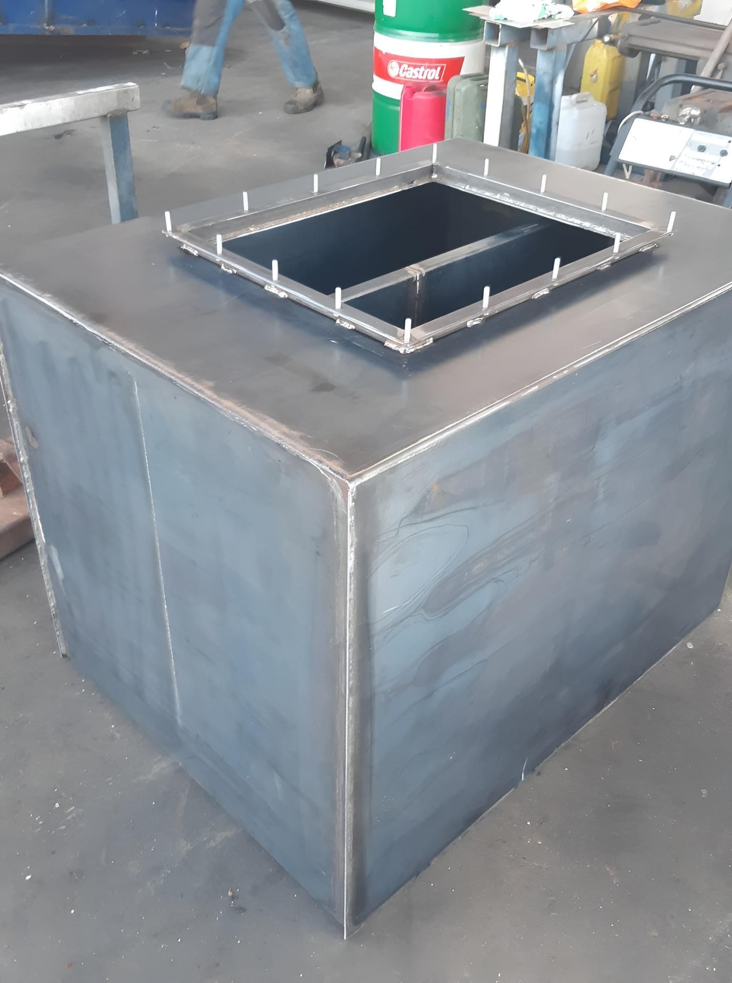 Industrial metal box with a square opening on top in a workshop