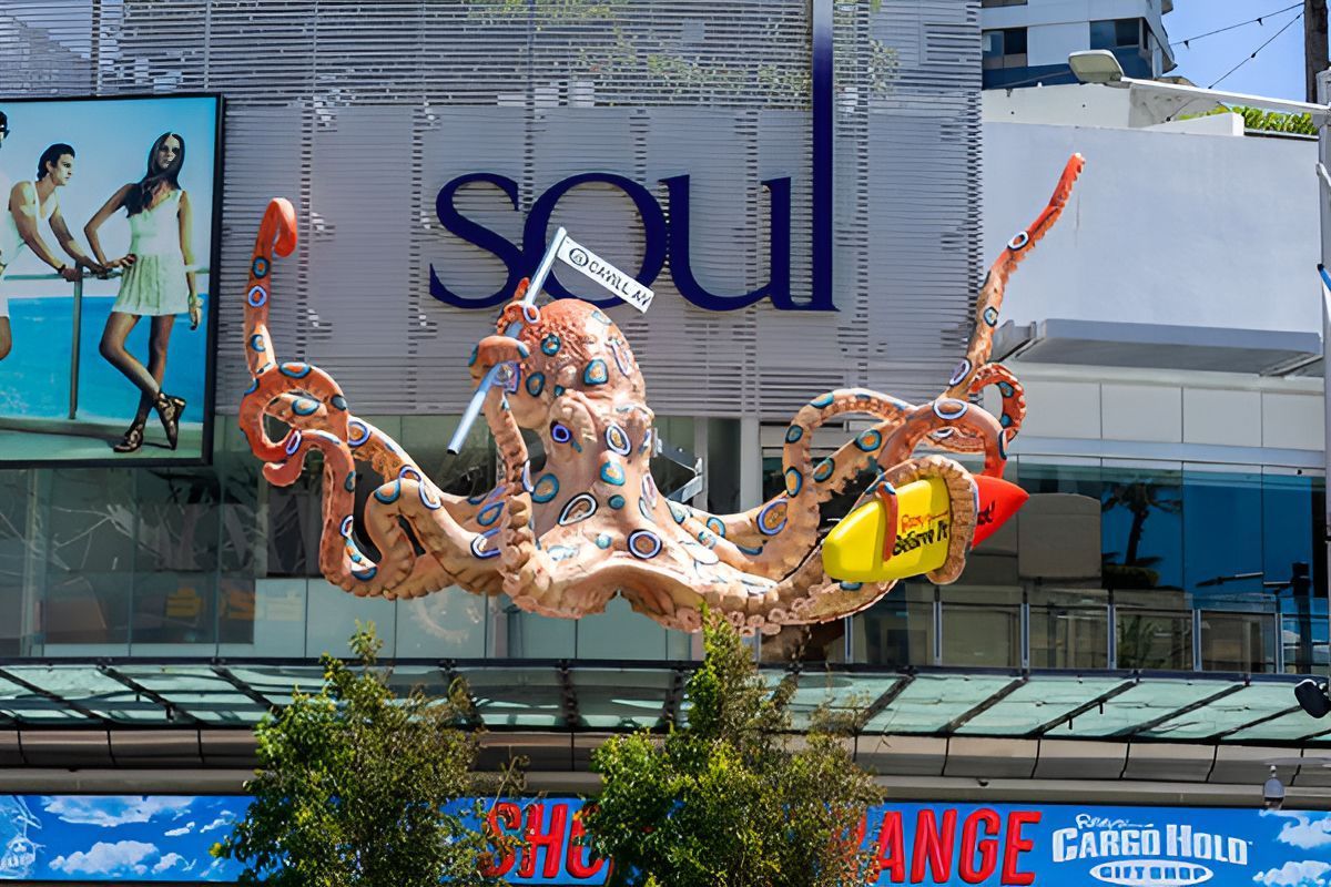 Colorful squid-shaped sculpture in front of a building sign reading “Seoul”