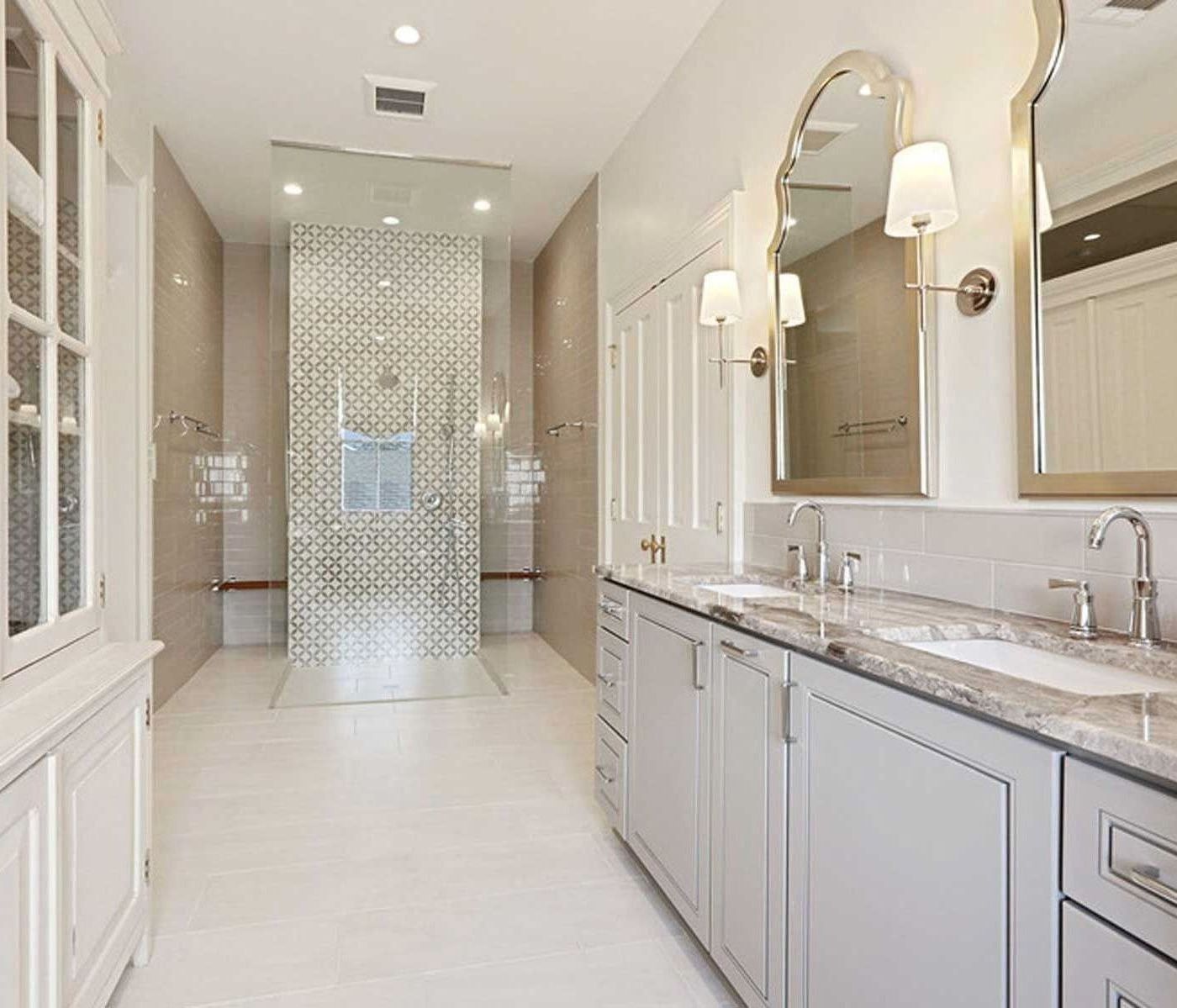 A bathroom with two sinks and a walk in shower