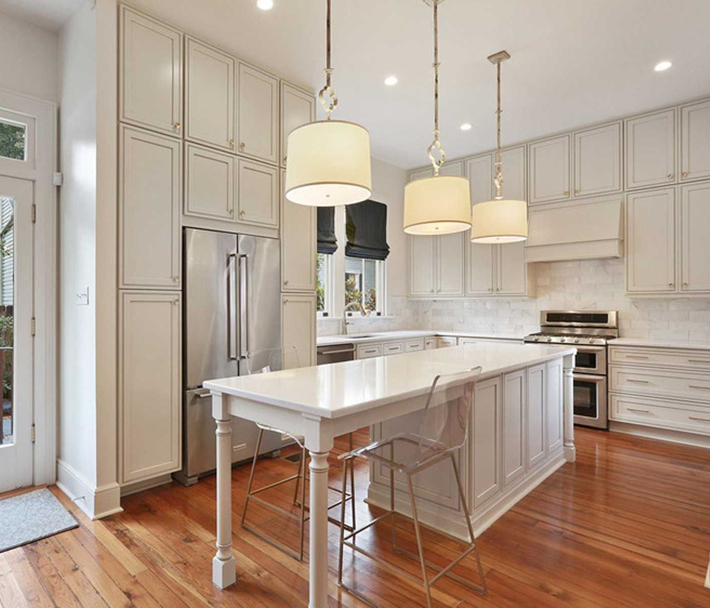 A kitchen with white cabinets and stainless steel appliances