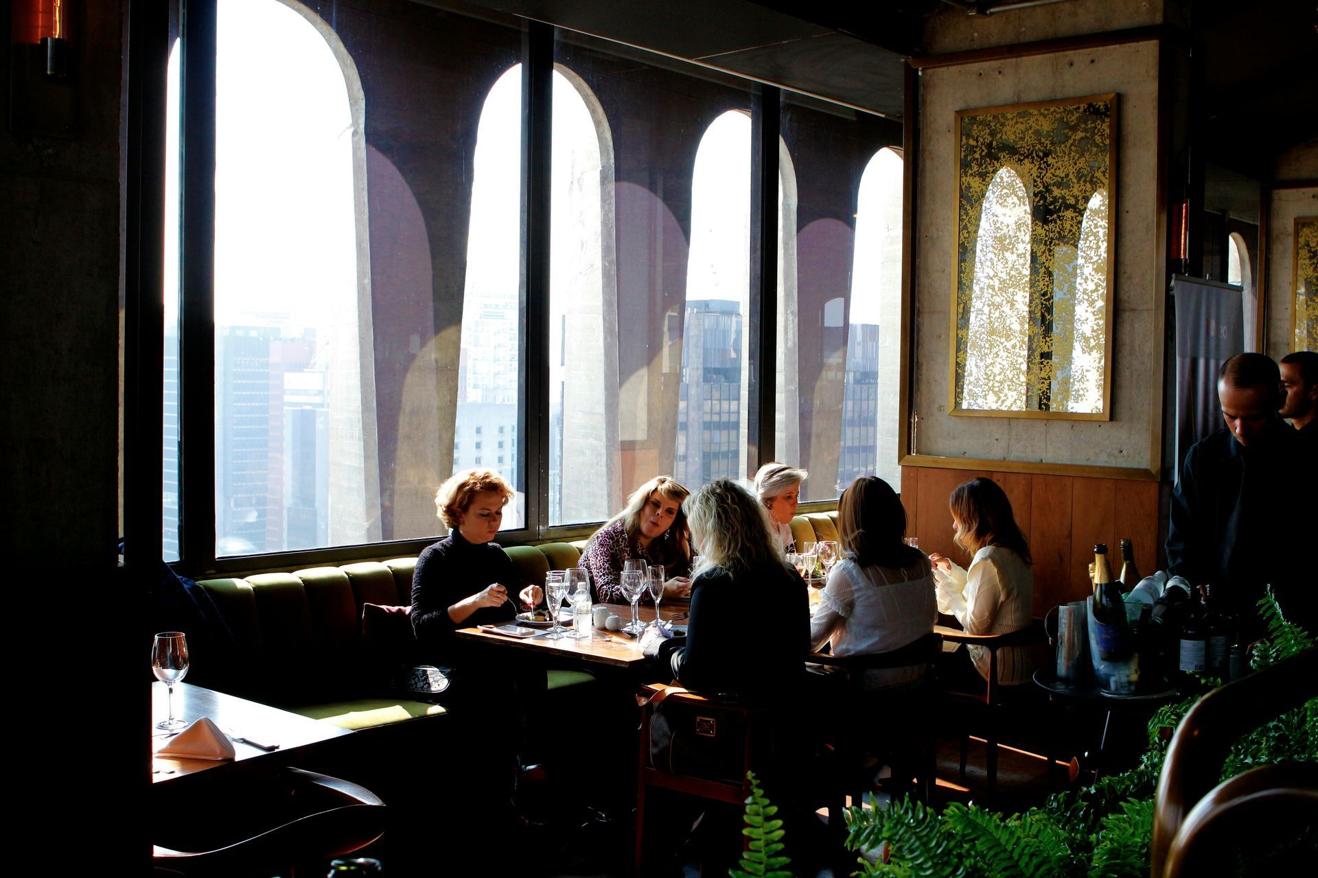 A group of people are sitting at tables in a restaurant