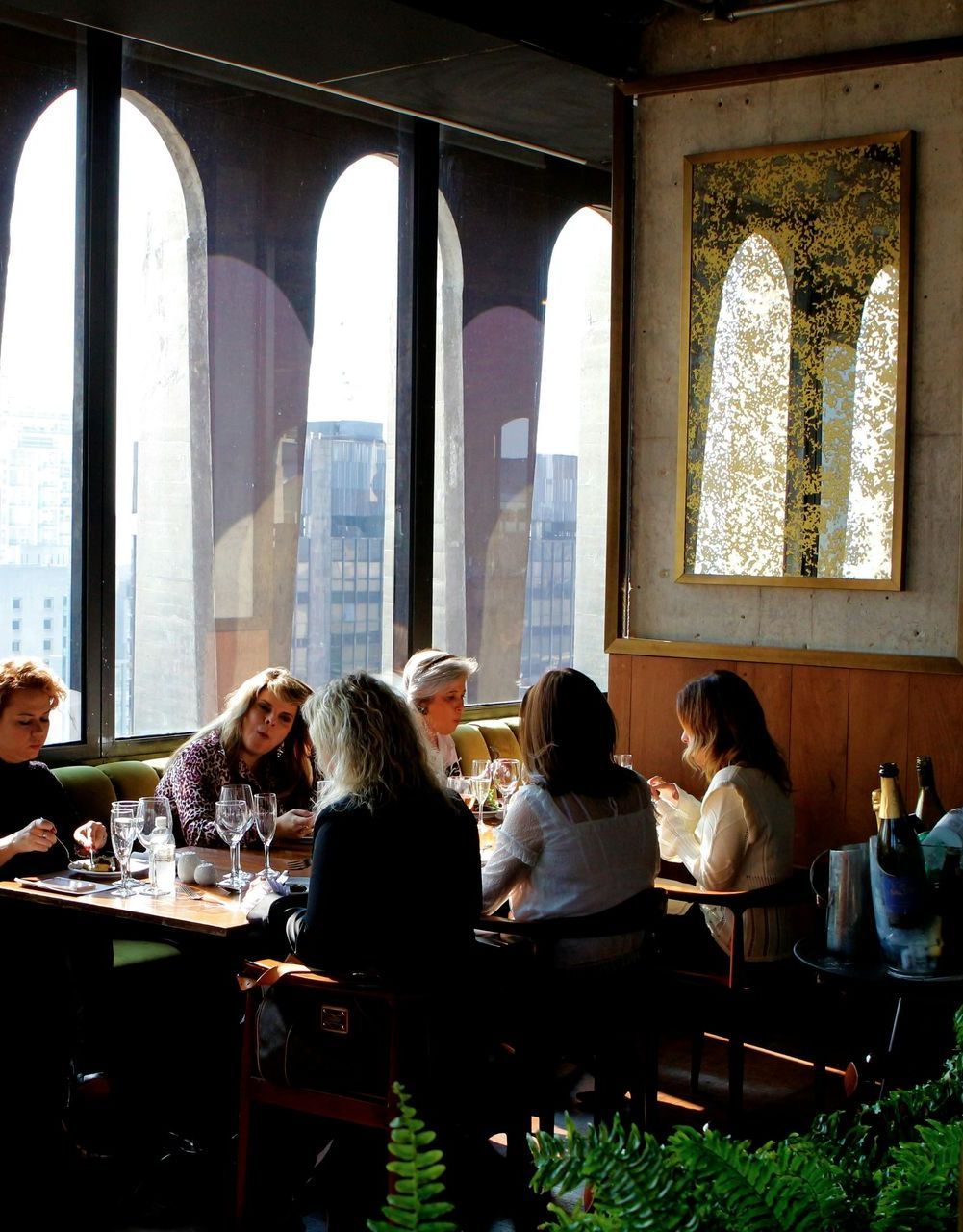 A group of people are sitting at tables in a restaurant