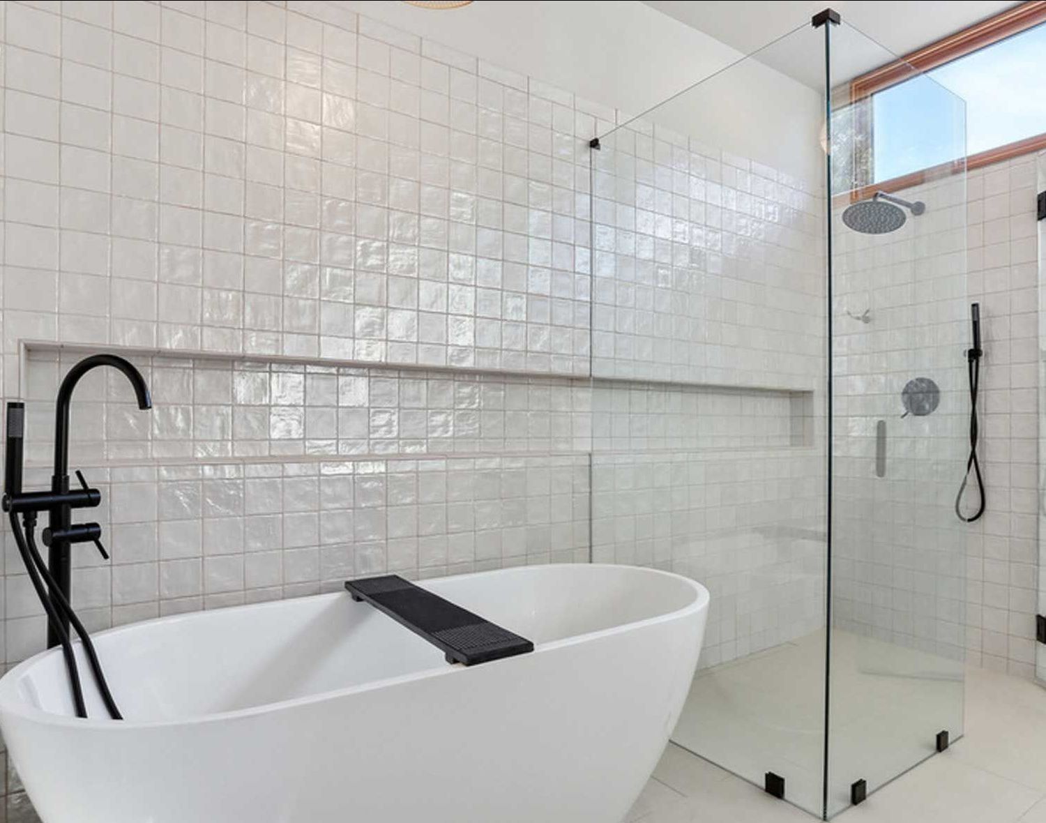 A bathroom with a bathtub and a walk in shower.