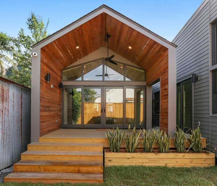 The back of a house with a wooden deck and stairs