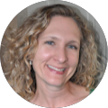 A woman with curly hair is smiling in a circle.