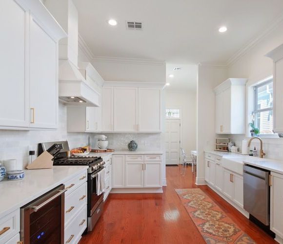 A kitchen with white cabinets and stainless steel appliances