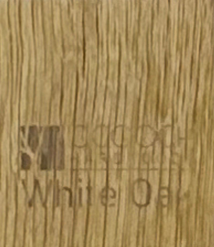 Wooden display case holding multiple trading cards, set on a wood floor.