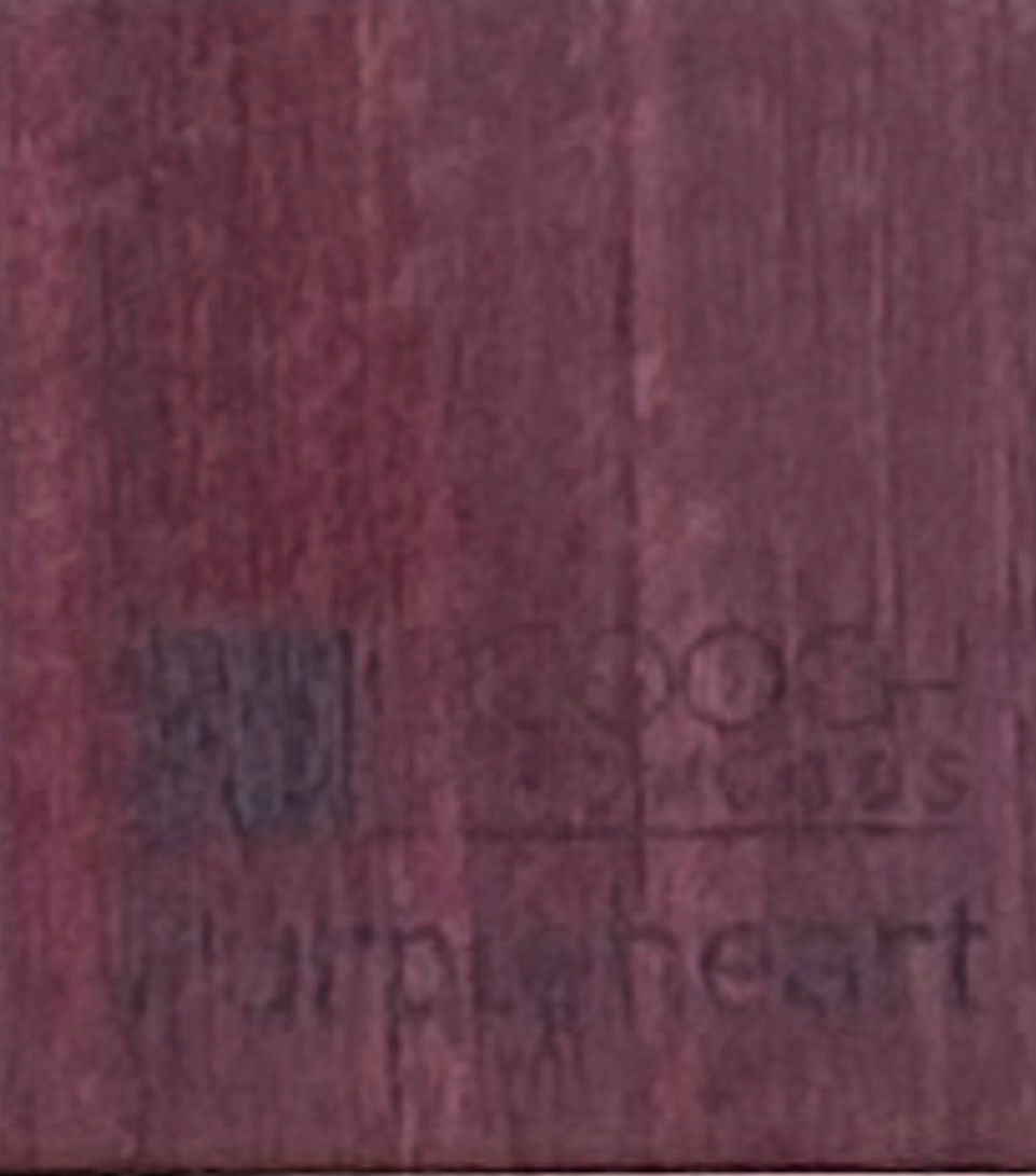 Purple-stained wood surface with the text 