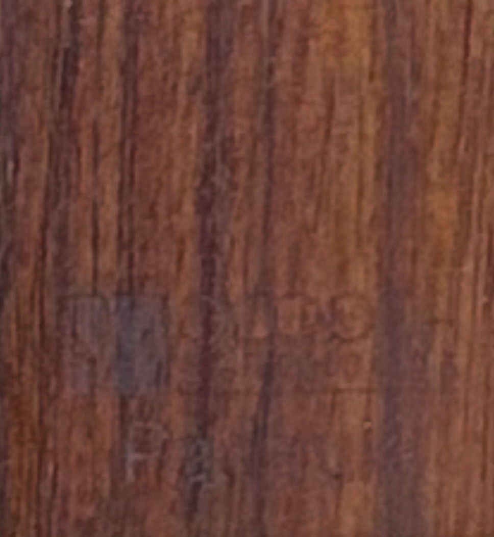 Wooden display case holding multiple trading cards, set on a wood floor.