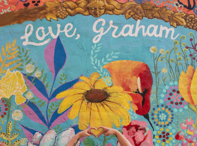 Colorful floral painting with the words “Love, Graham” and a yellow flower with a hummingbird