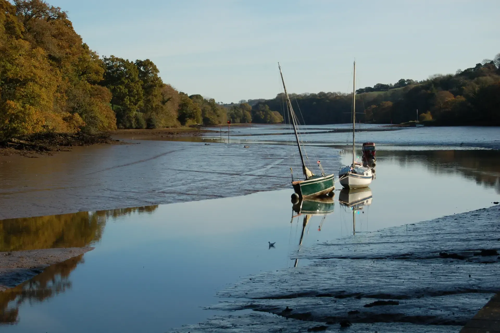 Debbie Nuttall Photographer | a couple of boats are sitting on the shore of a river