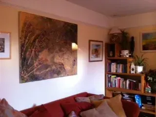 Debbie Nuttall Artist | a living room with a couch , bookshelf , and painting on the wall .