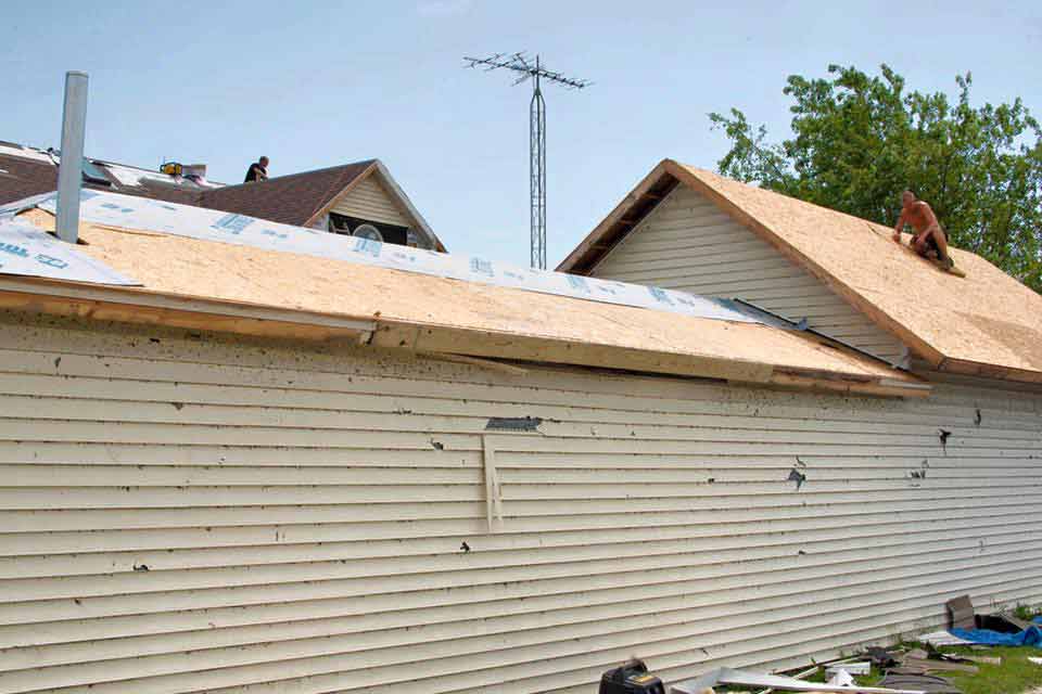 Man Repairing The Roof — Morris, IL — Shenberg Construction