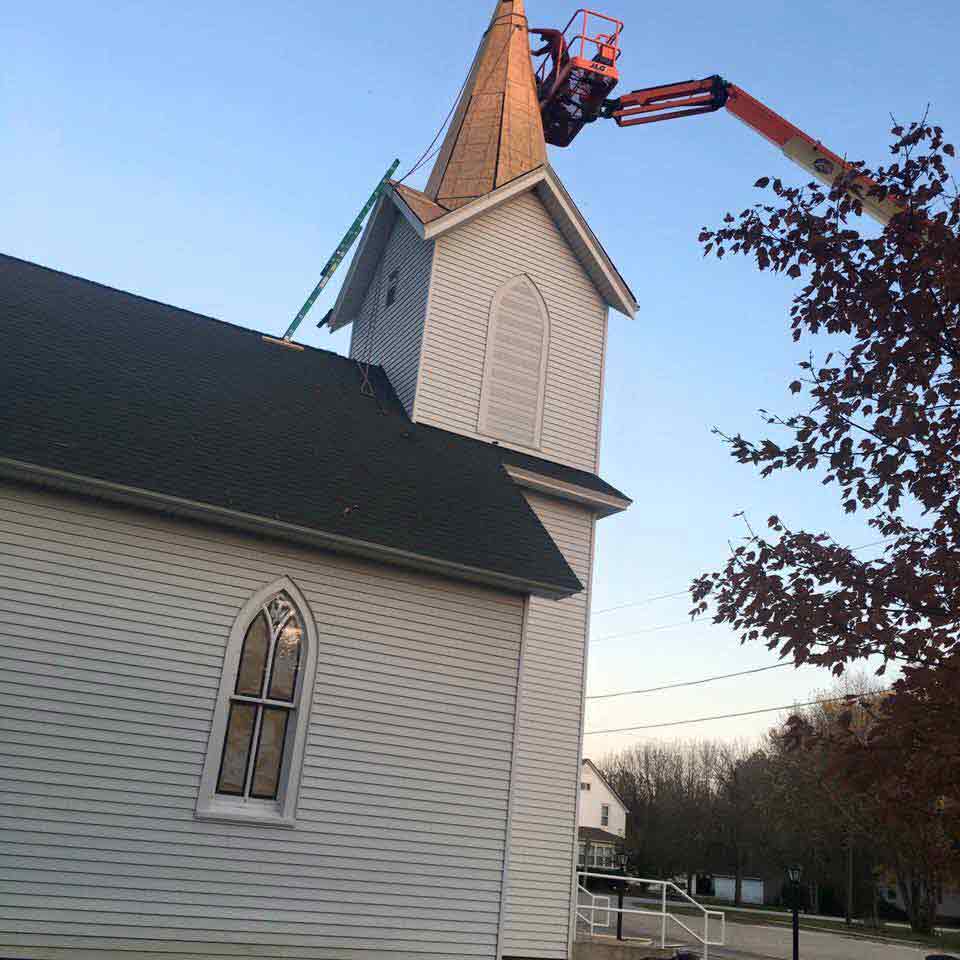 Bucket Truck With A Man Repairing The Roof — Morris, IL — Shenberg Construction