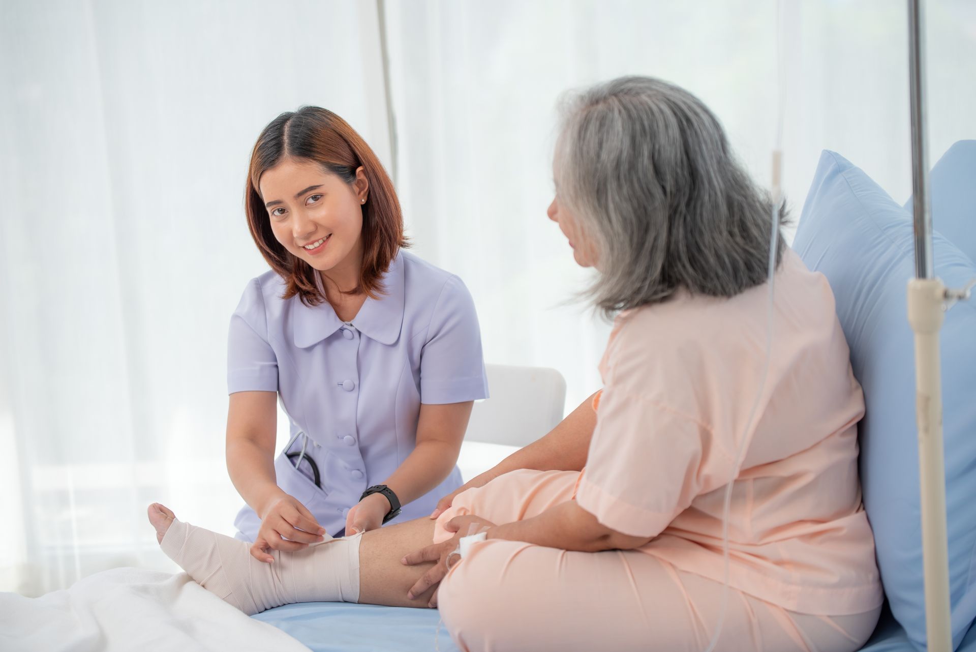 Nurse caring for an elderly patient.