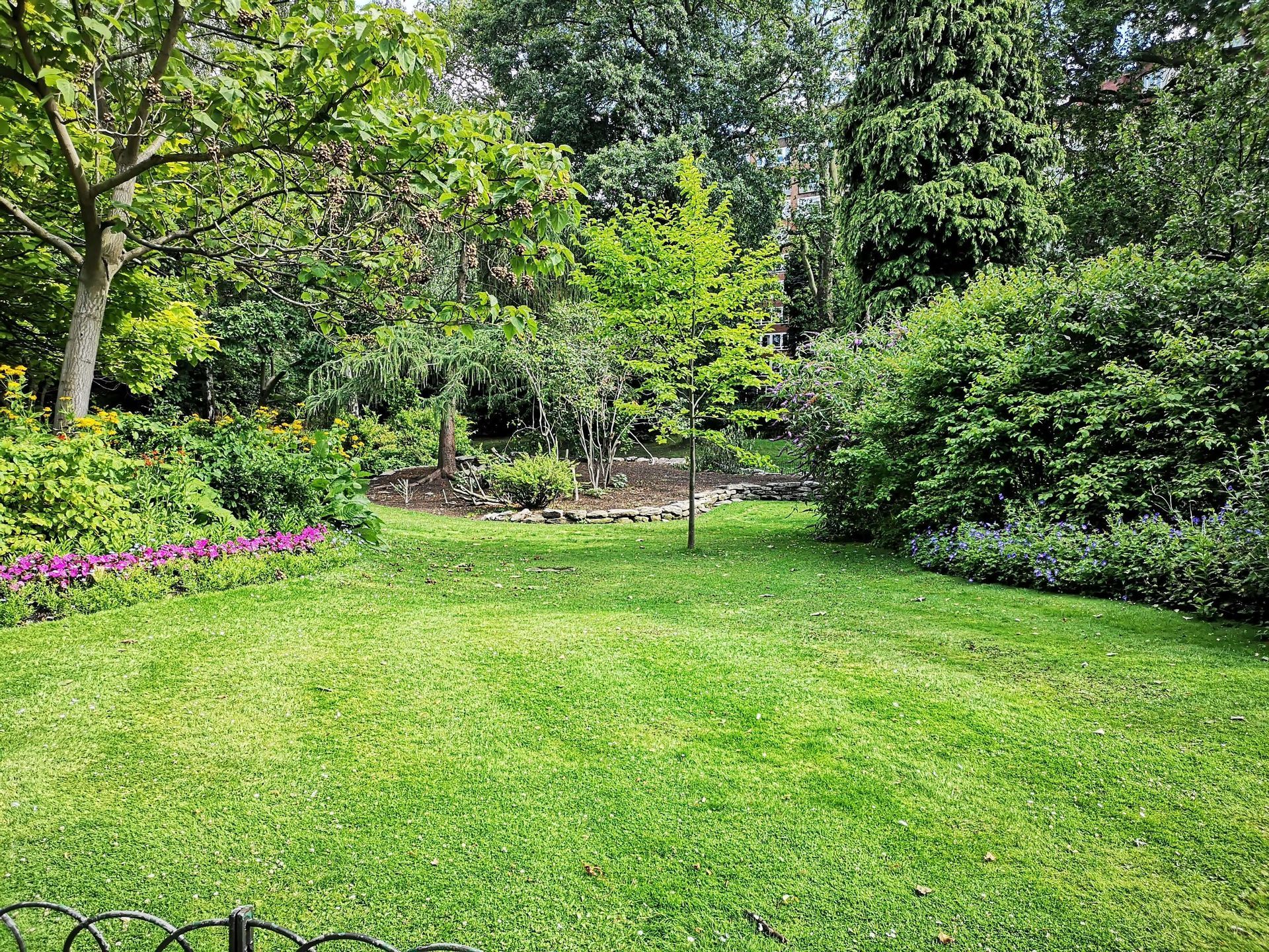 Well-maintained lawn and trees.