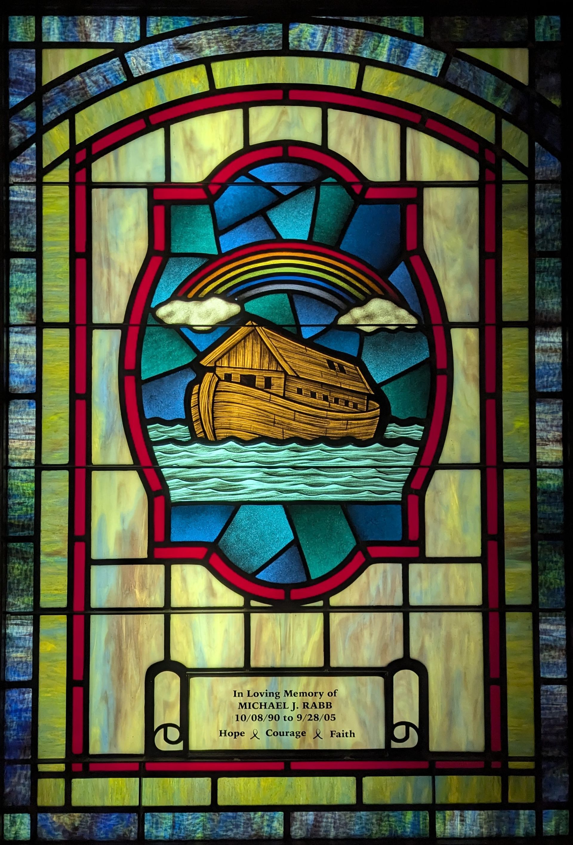 A stained glass window with a picture of the noah 's ark