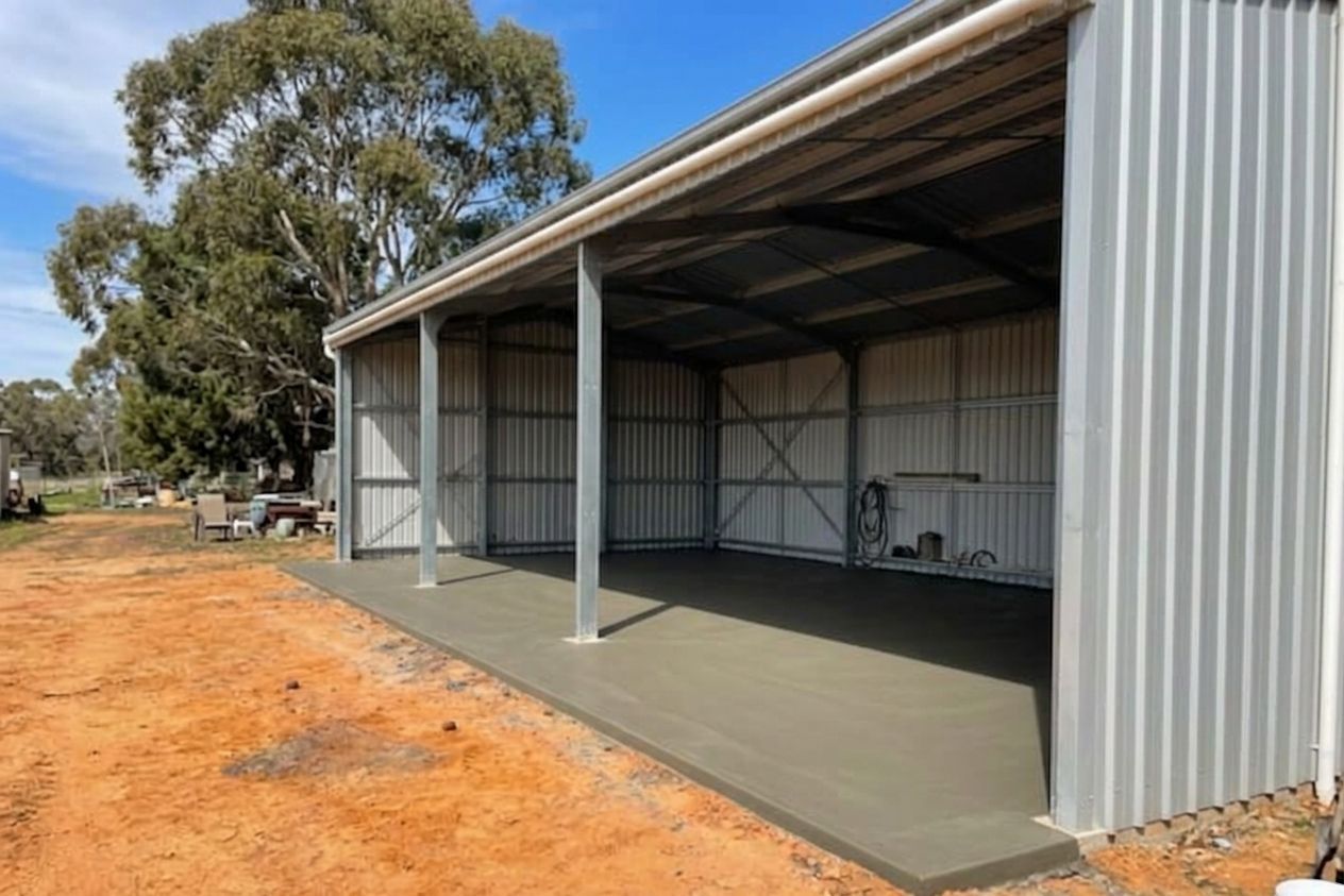 Smooth concrete shed slab under a steel shed in Kalamunda