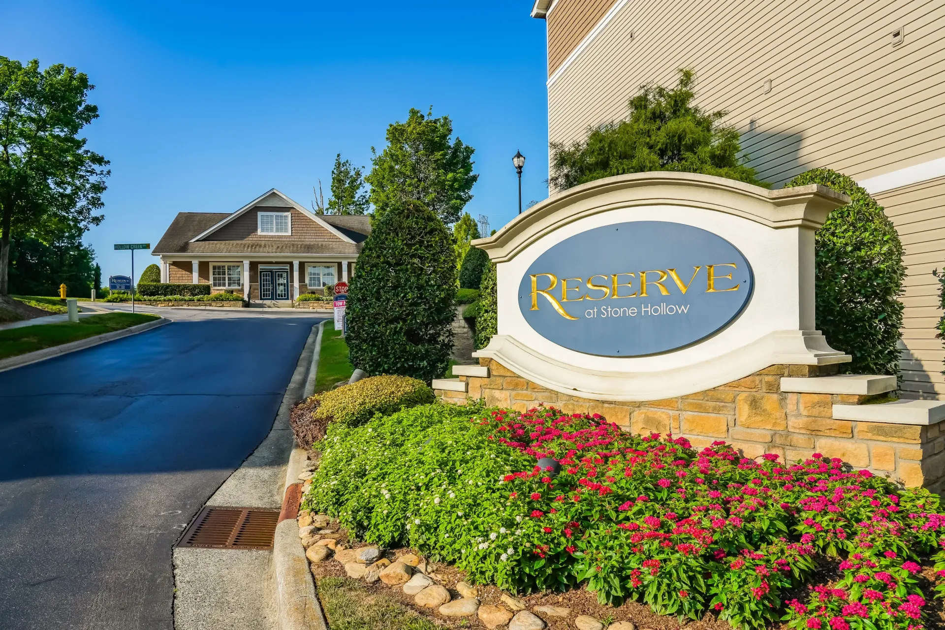 Reserve at Stone Hollow property signage with landscaping