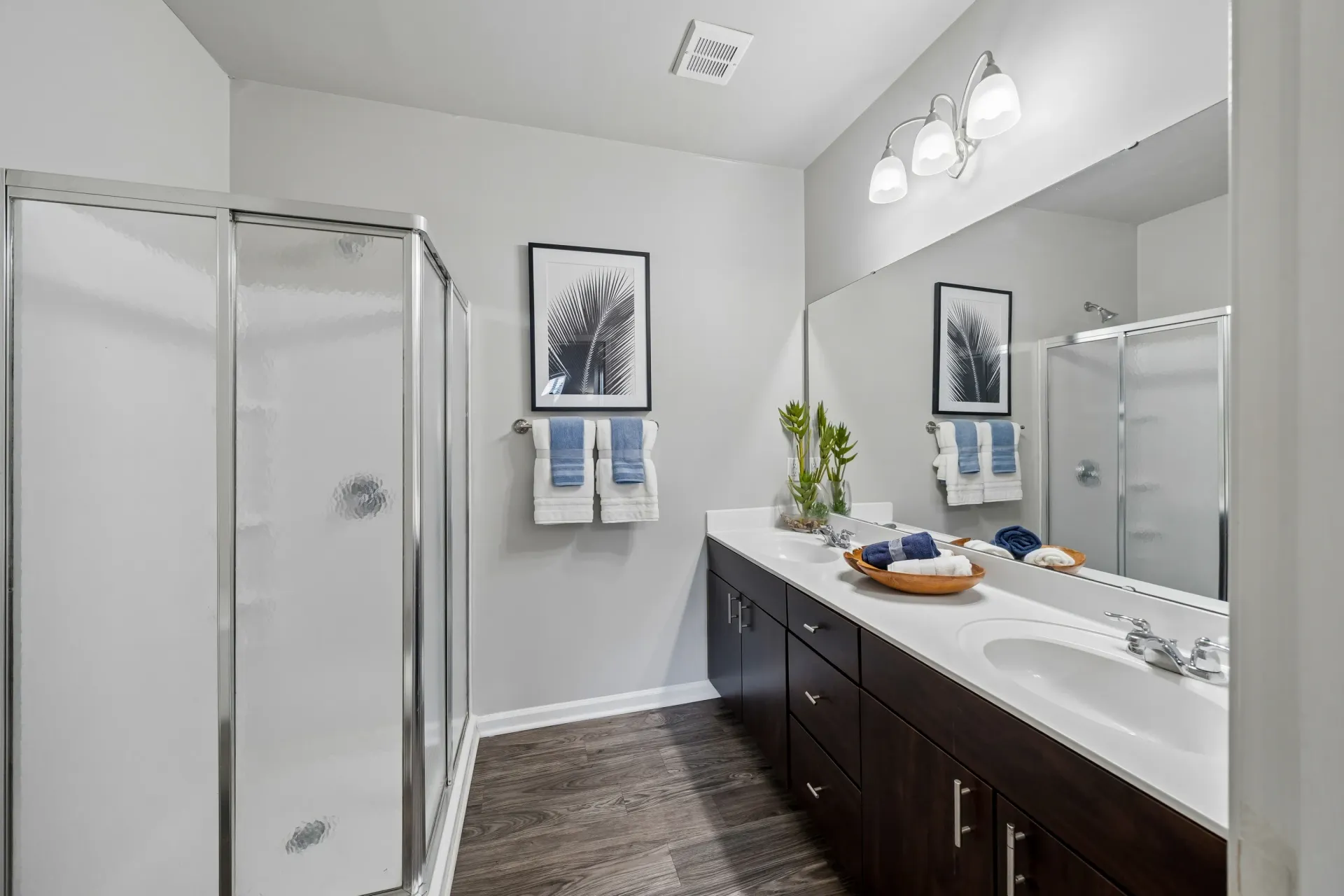 Modern bathroom with a glass shower and double vanity.