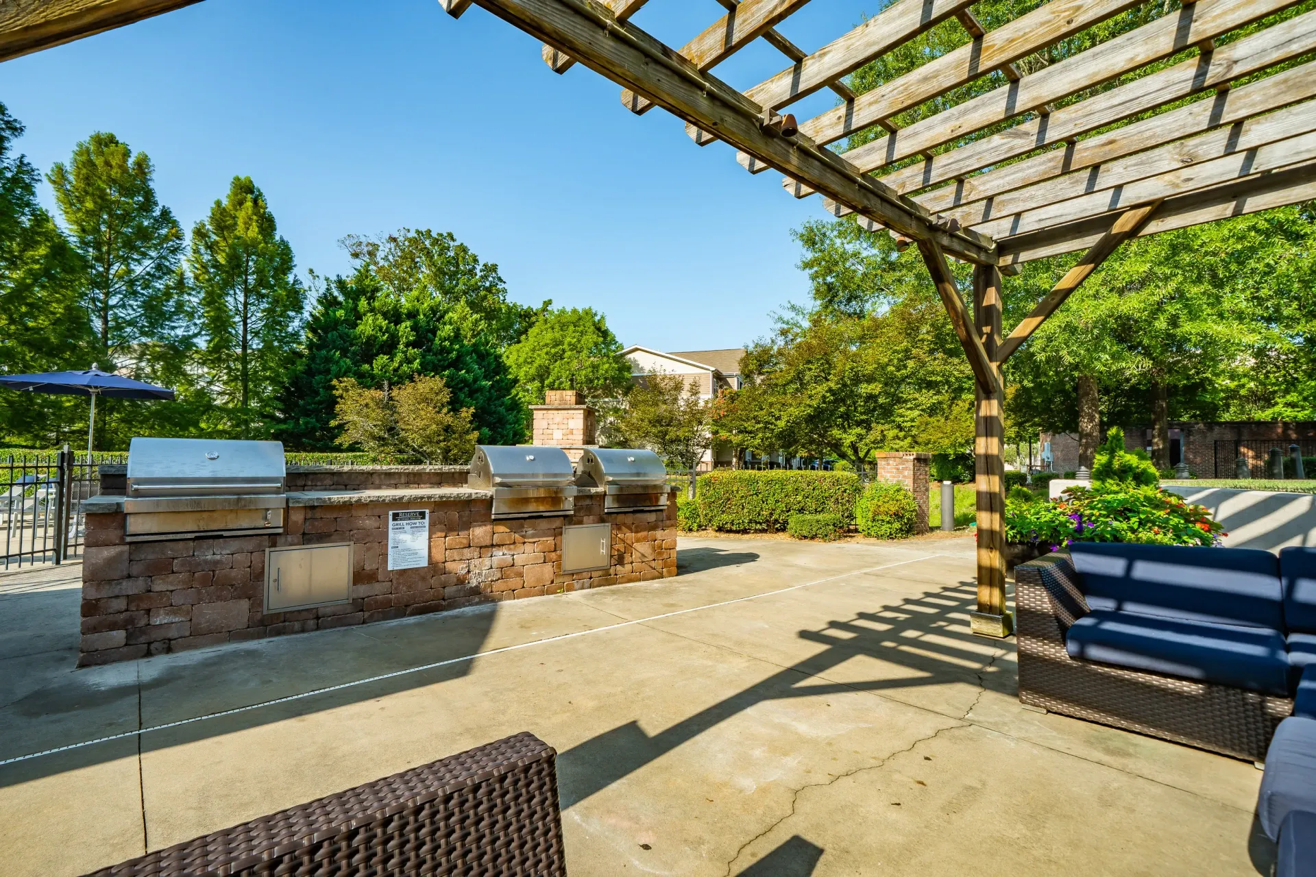 Outdoor kitchen area with grills and seating