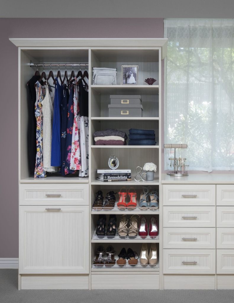 a kids custom closet system with shelving, clothing, and toys