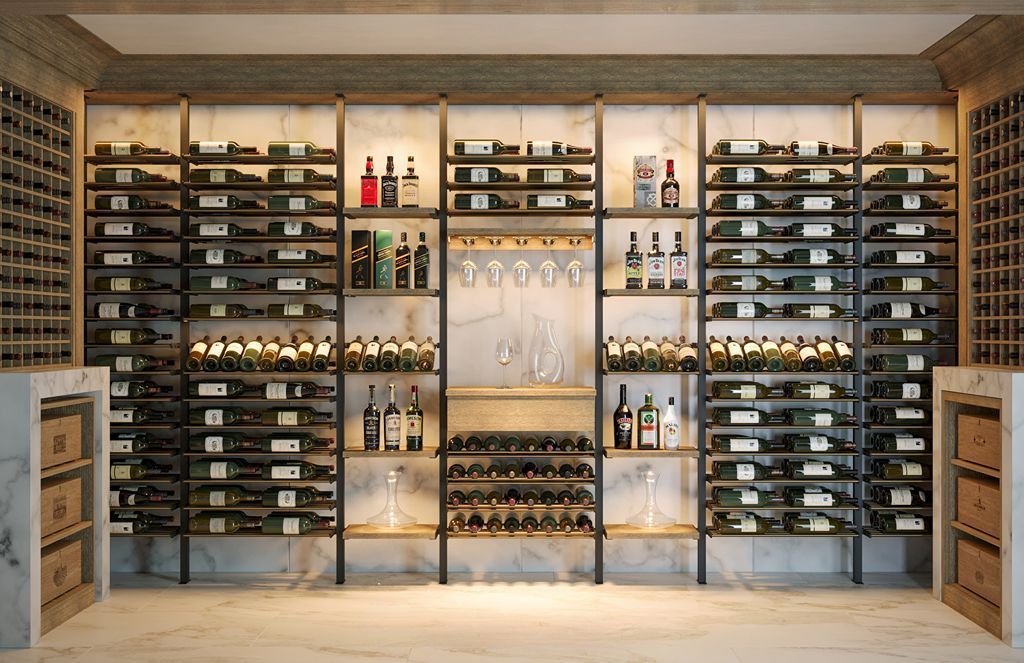 Wall of wine shelves in a rustic cellar, with bottles and glassware centered in a warm-lit display.