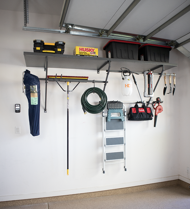 Garage wall with organized tools and storage shelves.