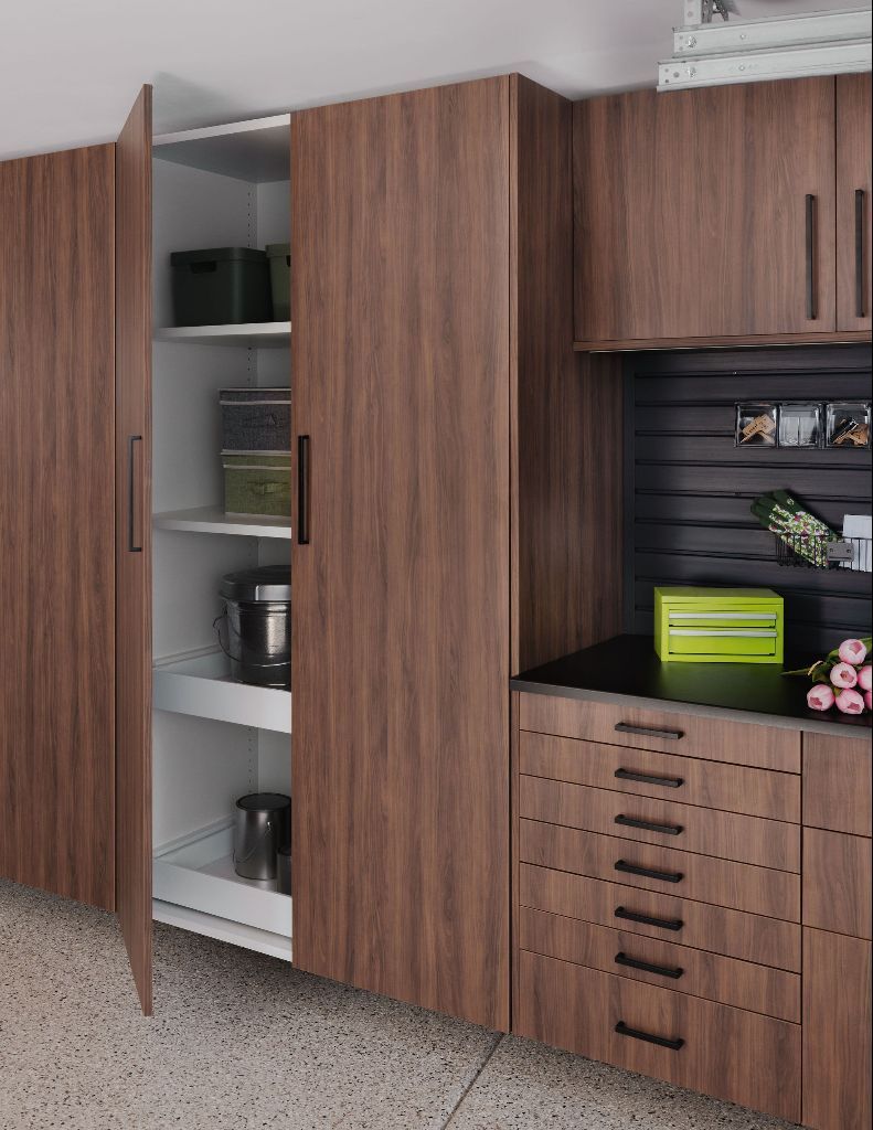 Wood-paneled storage cabinets with open shelves and drawers in a carpeted room.