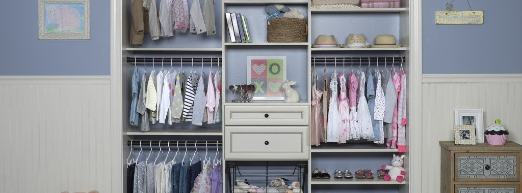 A closet filled with lots of clothes and a drawer.