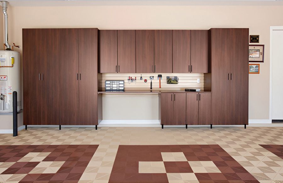 a garage with lots of cabinets and a swisstrax floor .