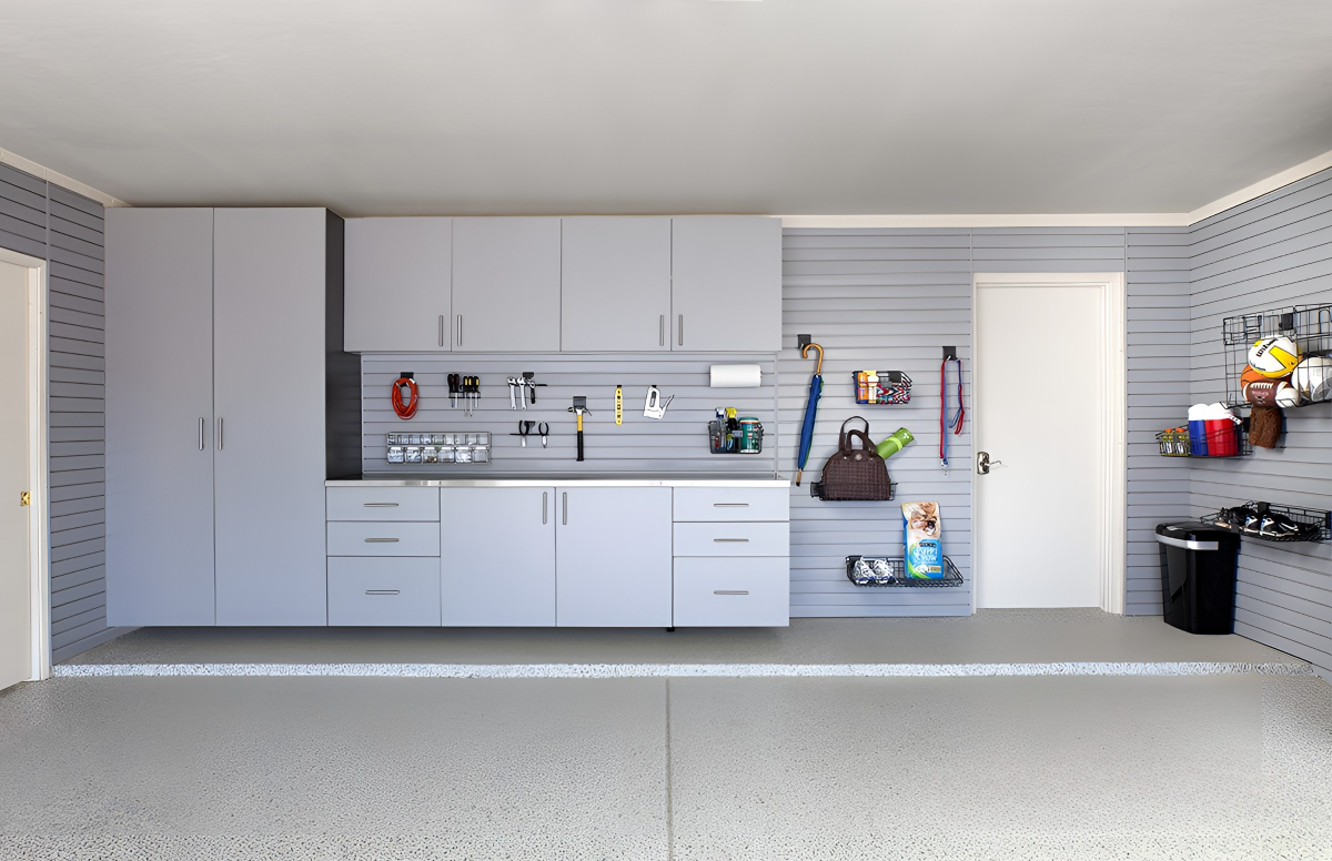 a garage with lots of cabinets and a swisstrax floor .