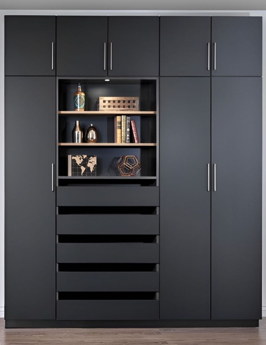 a reach in closet filled with clothes and a dresser .