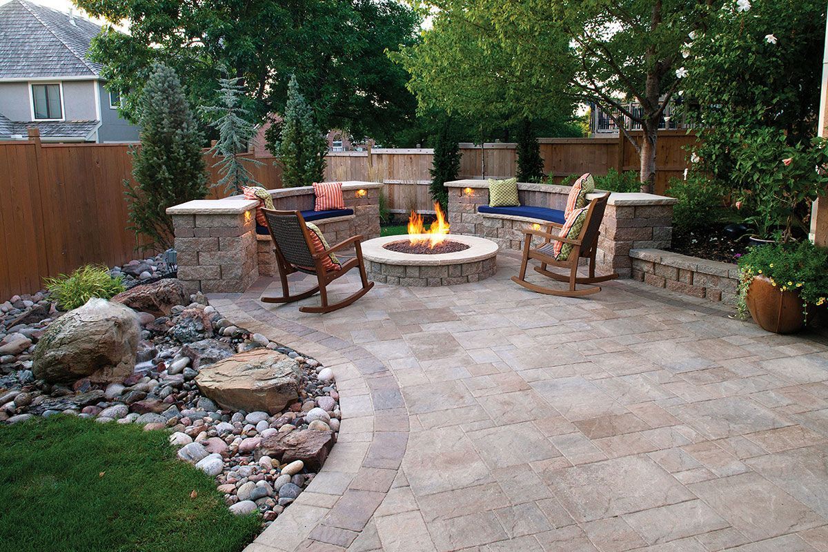There is a fire pit in the middle of the patio.